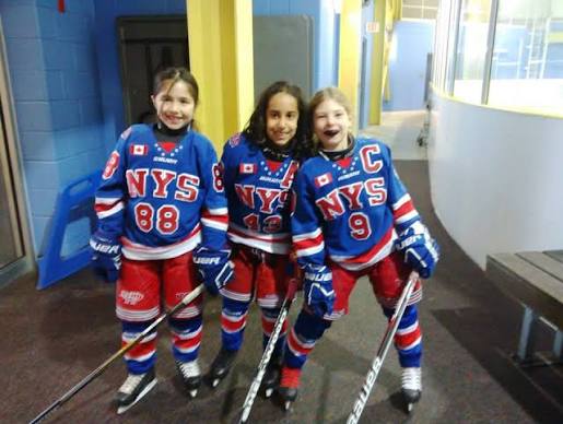 Three young North York Storm players in their hockey gear